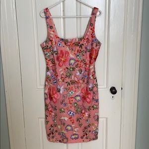 Sewn in floral pattern over a pink slip.